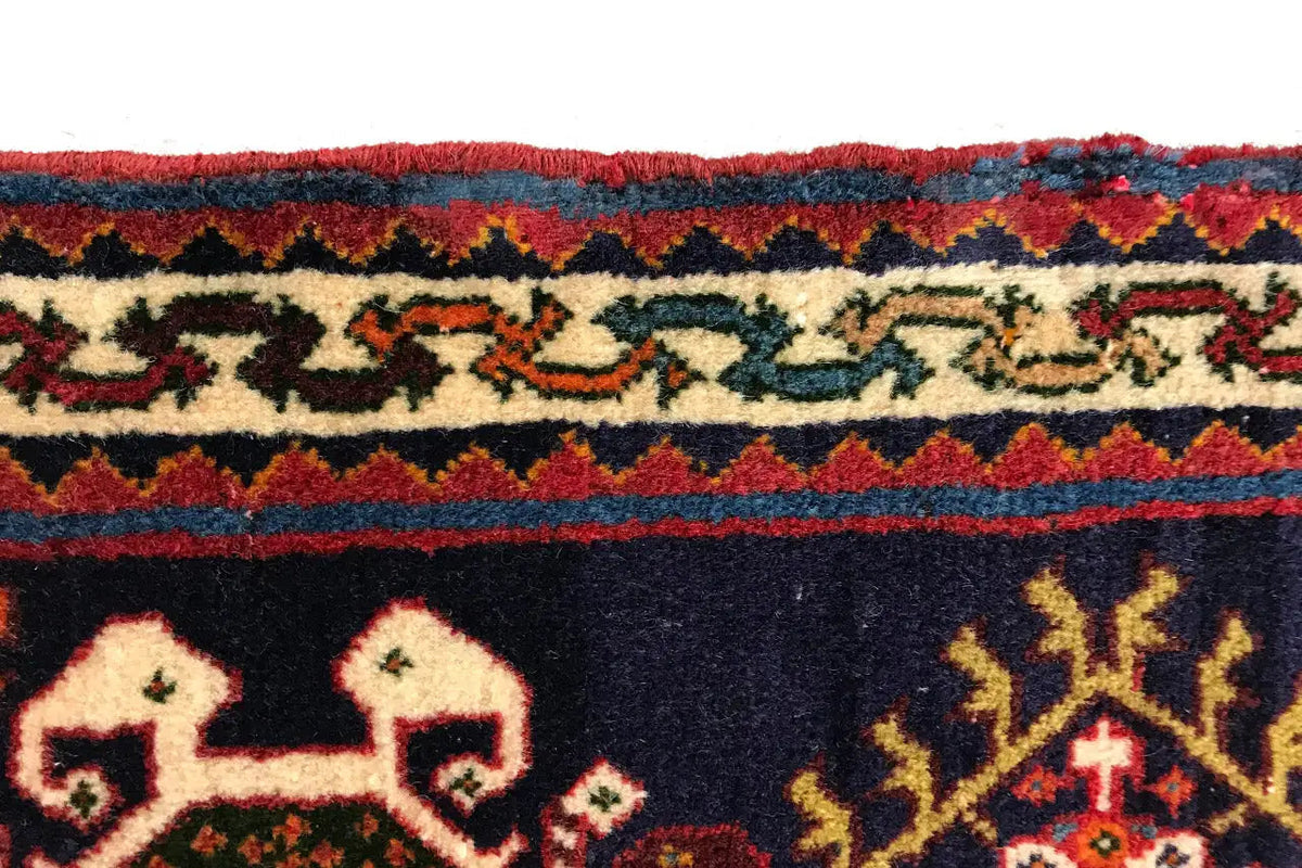 Carpet border with red and blue bands, ornamental frieze on a dark background