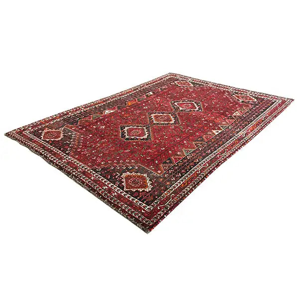 Red Oriental rug with geometric patterns and a surrounding border