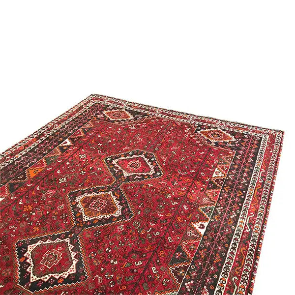 Oriental rug laid out: red field pattern with small geometric motifs