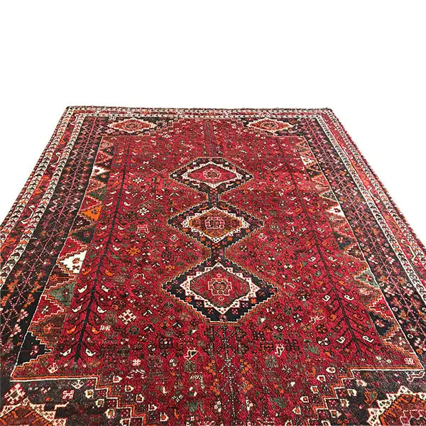 Red carpet with a symmetrical medallion design and striped side borders