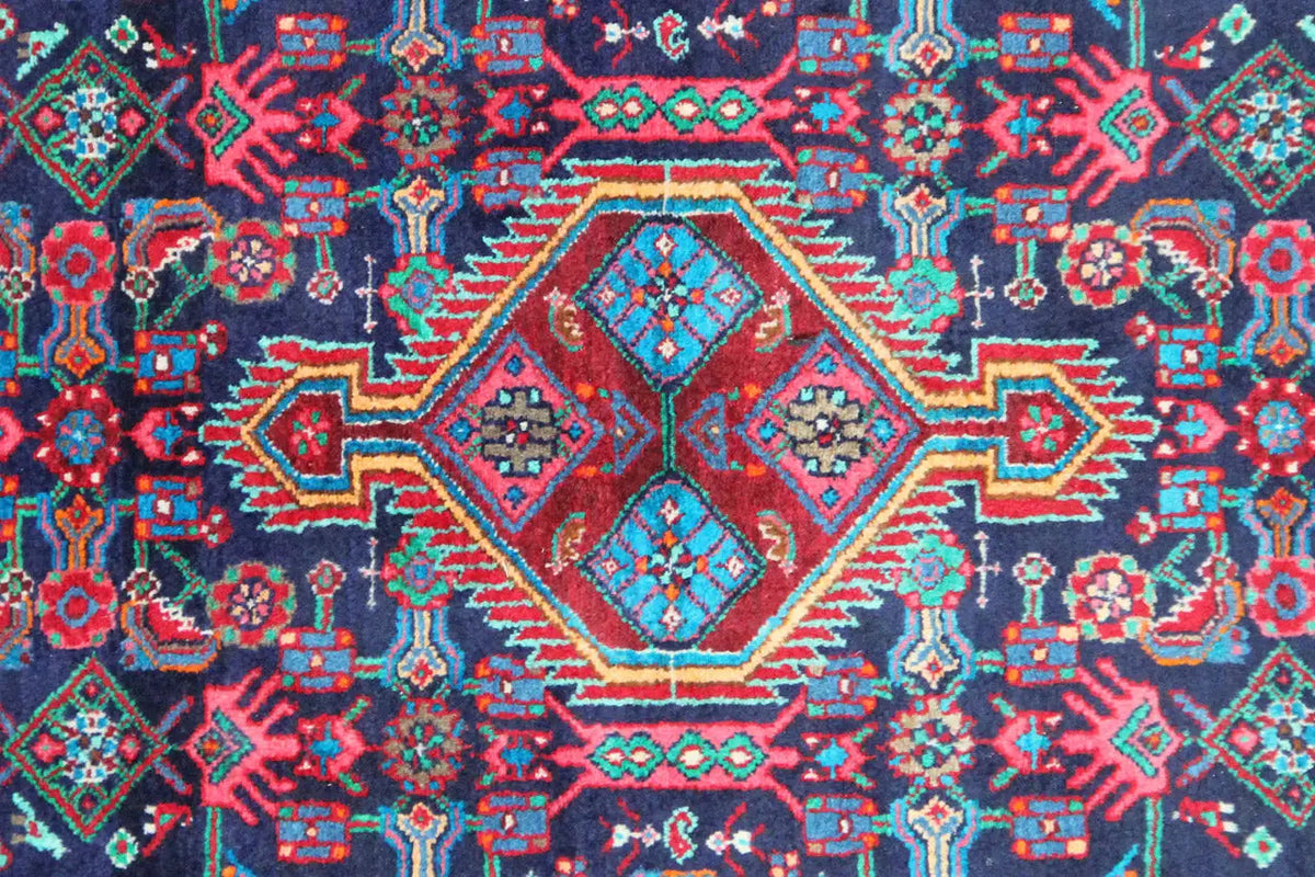 Rug pattern with a central diamond and many blue and red ornaments