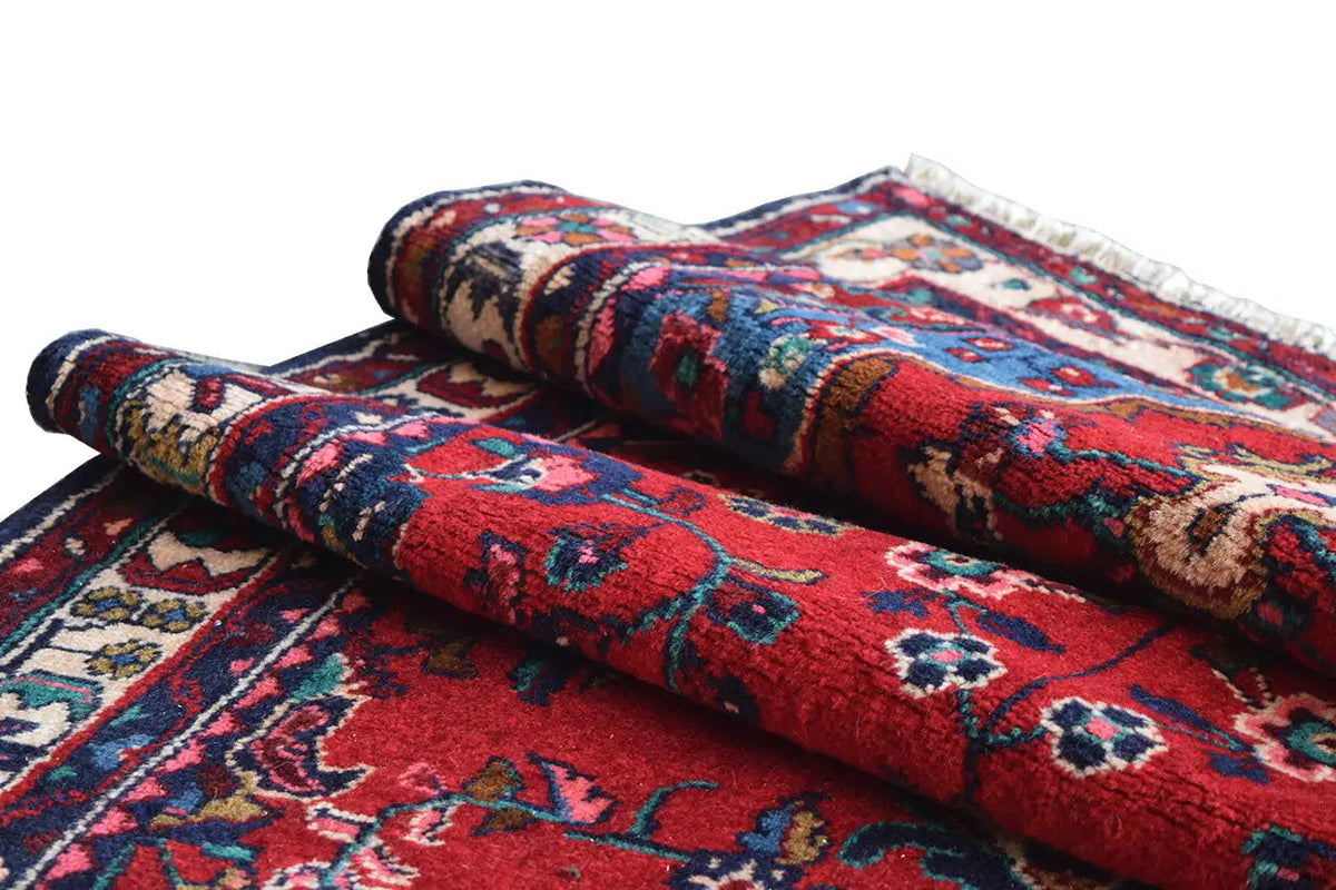 Hamadan runner: rolled up with a red pattern and multicolored border