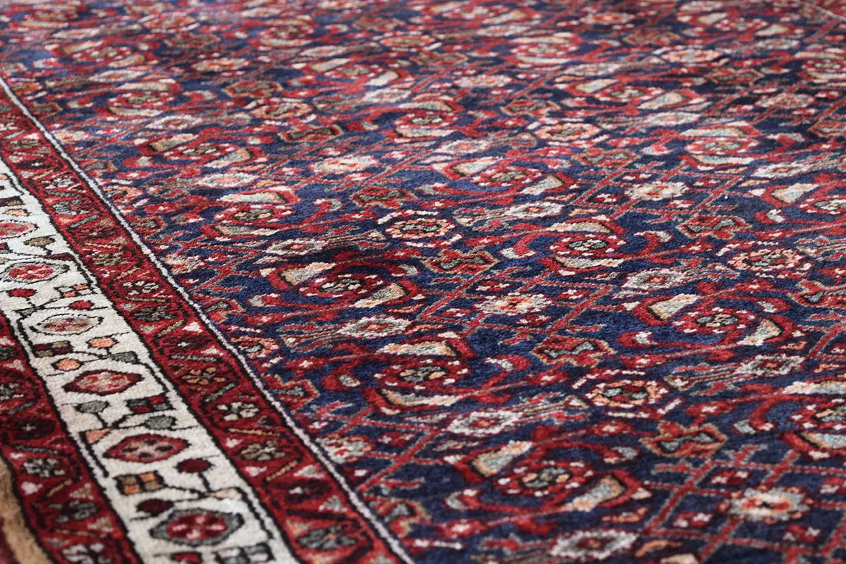 Oriental rug runner surface: dense blue-red-white ornamental design covering the entire surface
