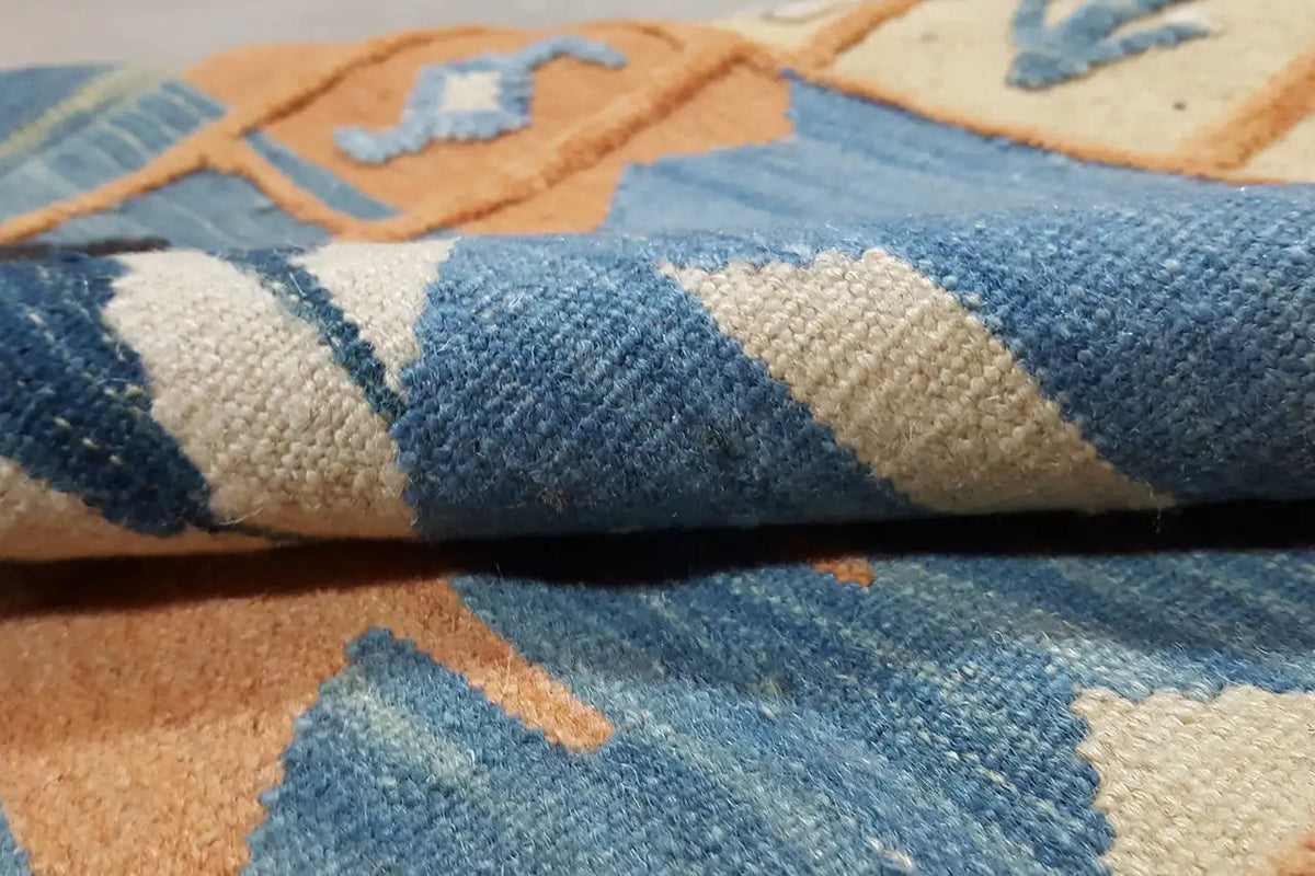Kilim rug, close-up: blue and beige pattern with a dense weave