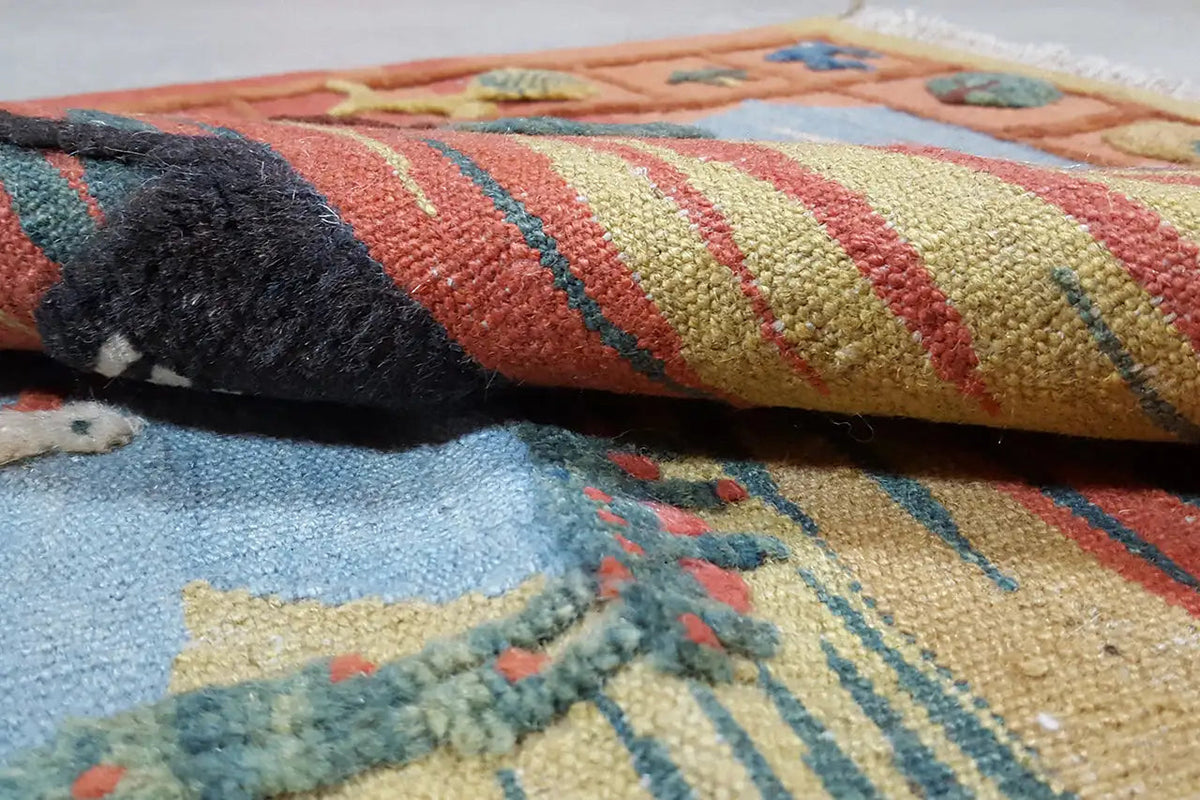 Kilim rug close-up: woven texture with multicolored patterns and fringed edges