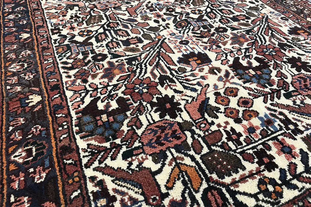Oriental rug runner with a multicolored ornamental pattern, dark border, and fringe