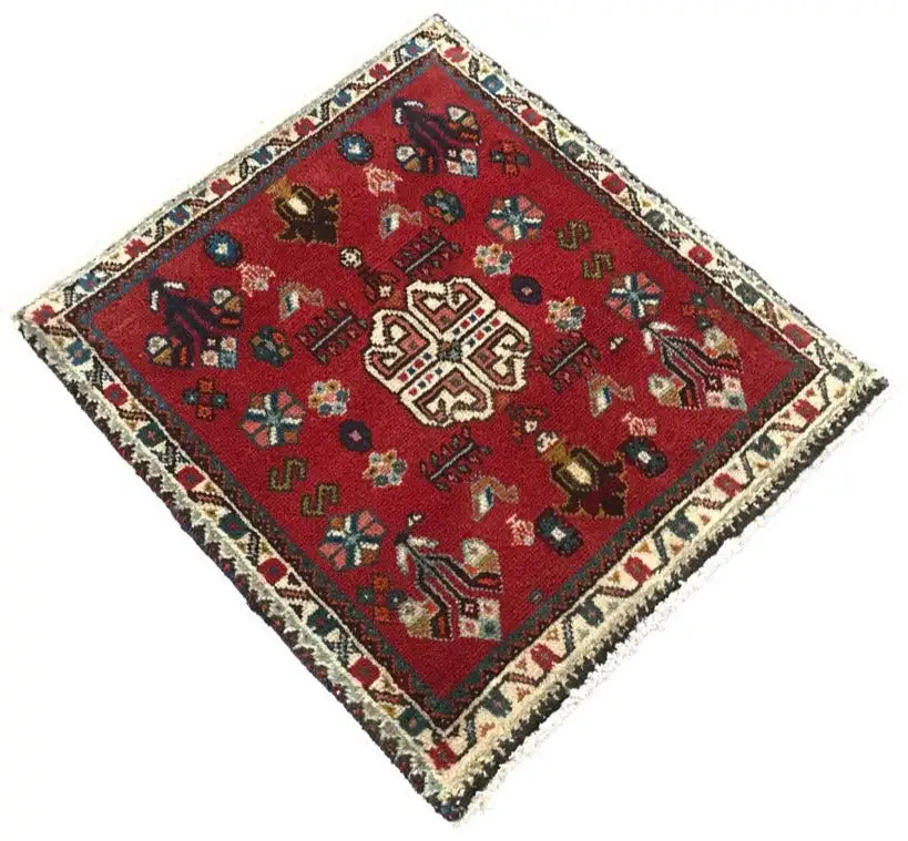Red Oriental rug with a square medallion, surrounding border, and fringes