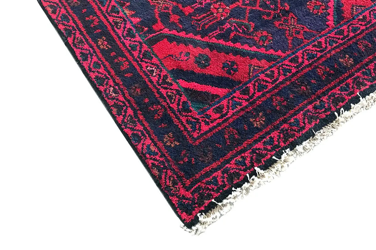 Hamadan runner rug with burgundy patterns, dark blue borders, and fringes