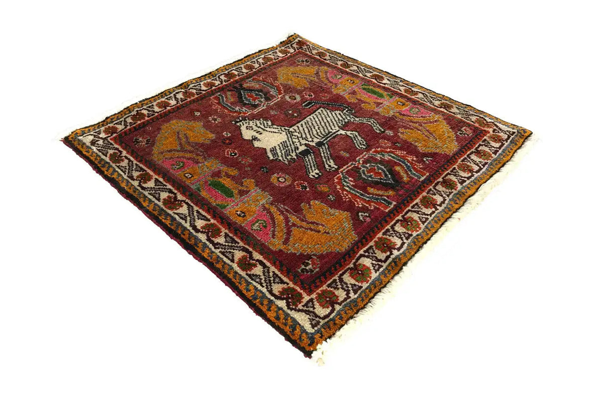 Rectangular rug with a red ground and horse figure, framed by a border