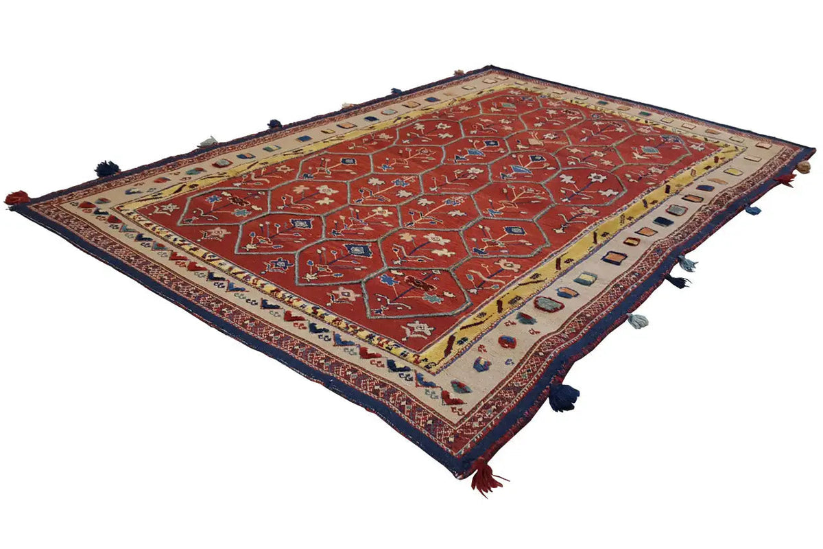 Reddish-brown Oriental rug with a geometric pattern and fringes at the corners