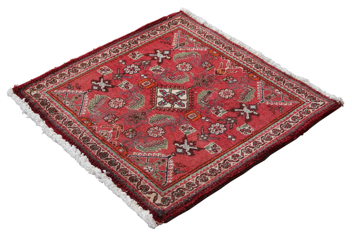 Red square-design rug with border and white fringed edge