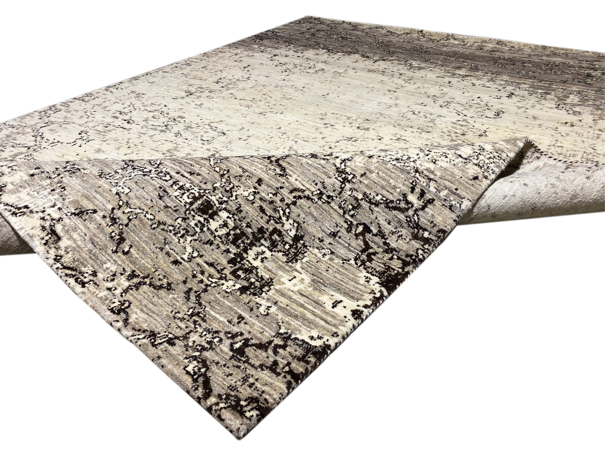 Teppich diagonal ausgelegt mit hellem Beigegrund und dunkelgrauen Ornamentlinien