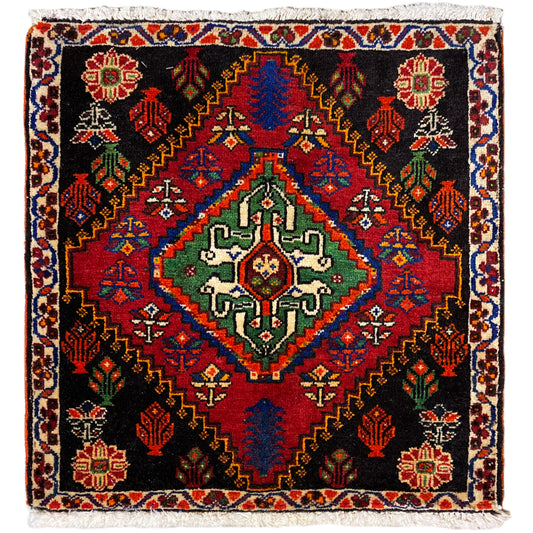 Poshti rug 56x56 cm with a black background, colorful ornaments, and decorative fringes