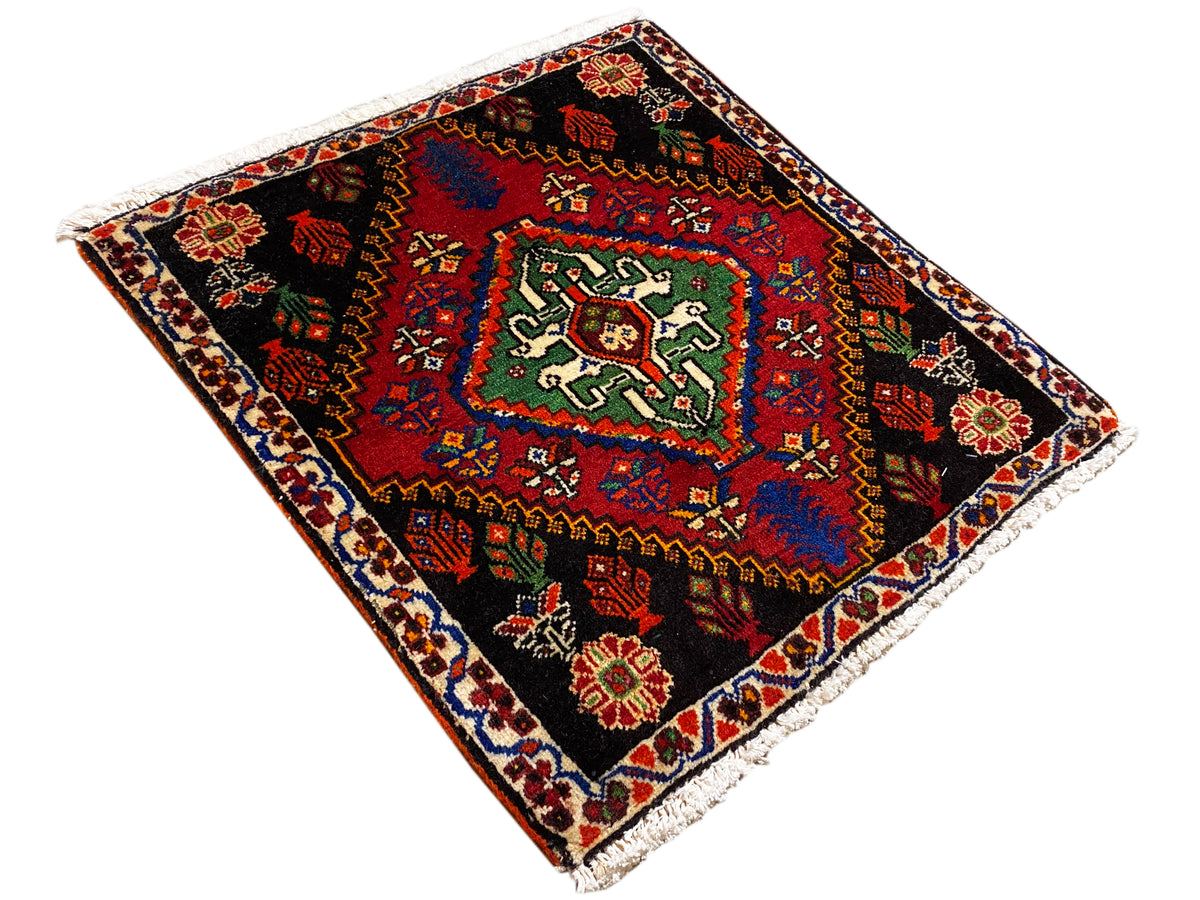 Poshti rug 56x56 cm, laid diagonally, geometric patterns in red, green, and blue