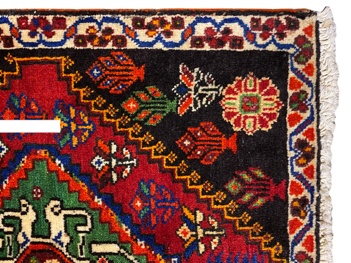 Poshti rug 56x56 cm close-up: ornamental border with colorful diamonds on a black background