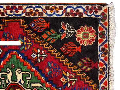 Poshti rug 56x56 cm close-up: ornamental border with colorful diamonds on a black background