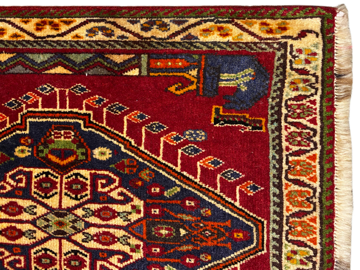 Detail of the Poshti rug (59×61 cm): red field with carpet ornaments and a bordered edge