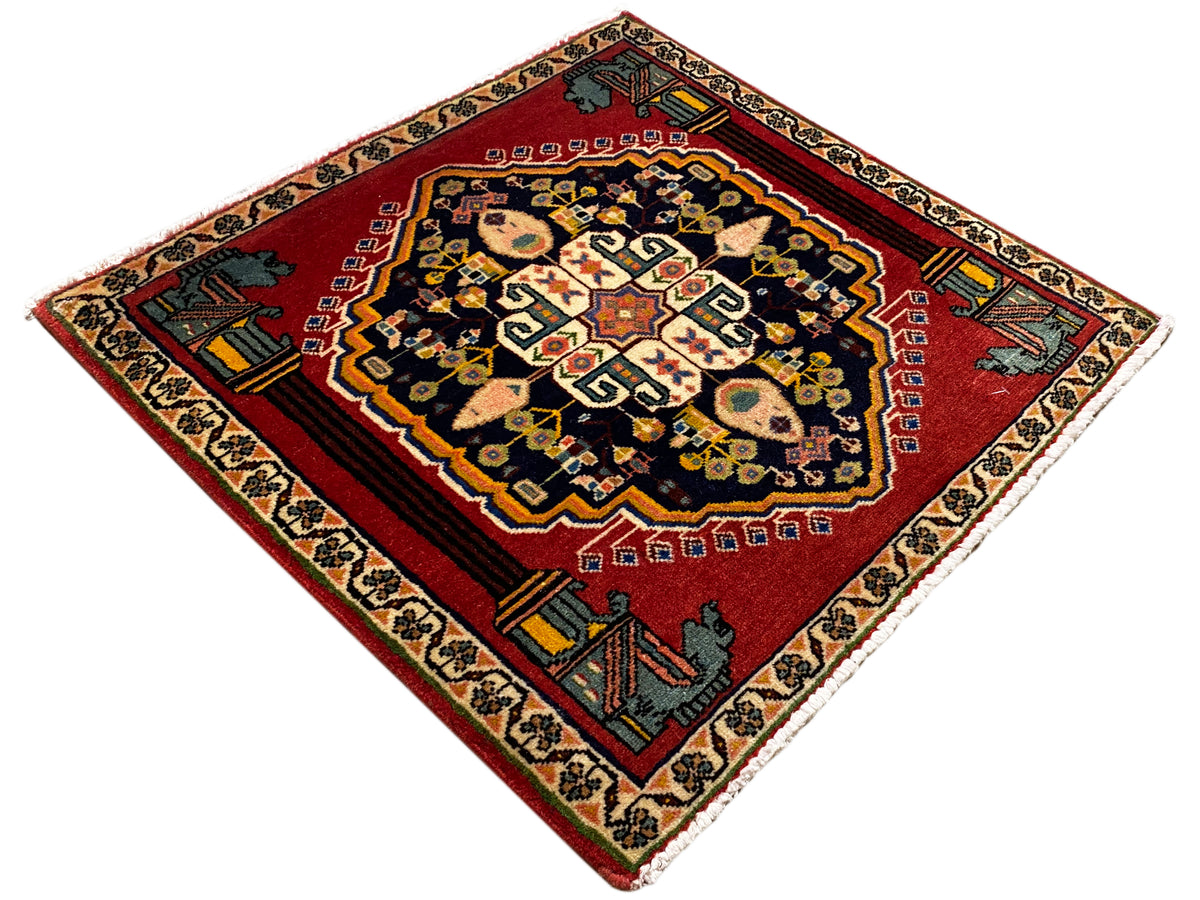 Poshti rug in a diamond pattern with a red background, dark medallion, and corner ornaments