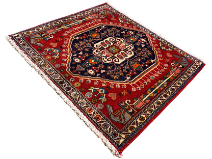 Rug with a red background and dark central medallion, rectangular, finished with fringes