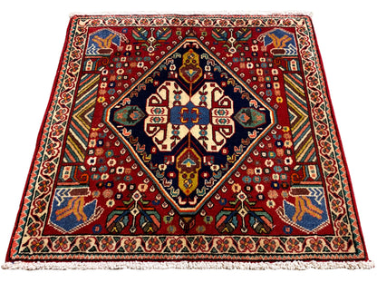 Carpet 66x62 cm with a red pattern, dark border, and colorful ornaments
