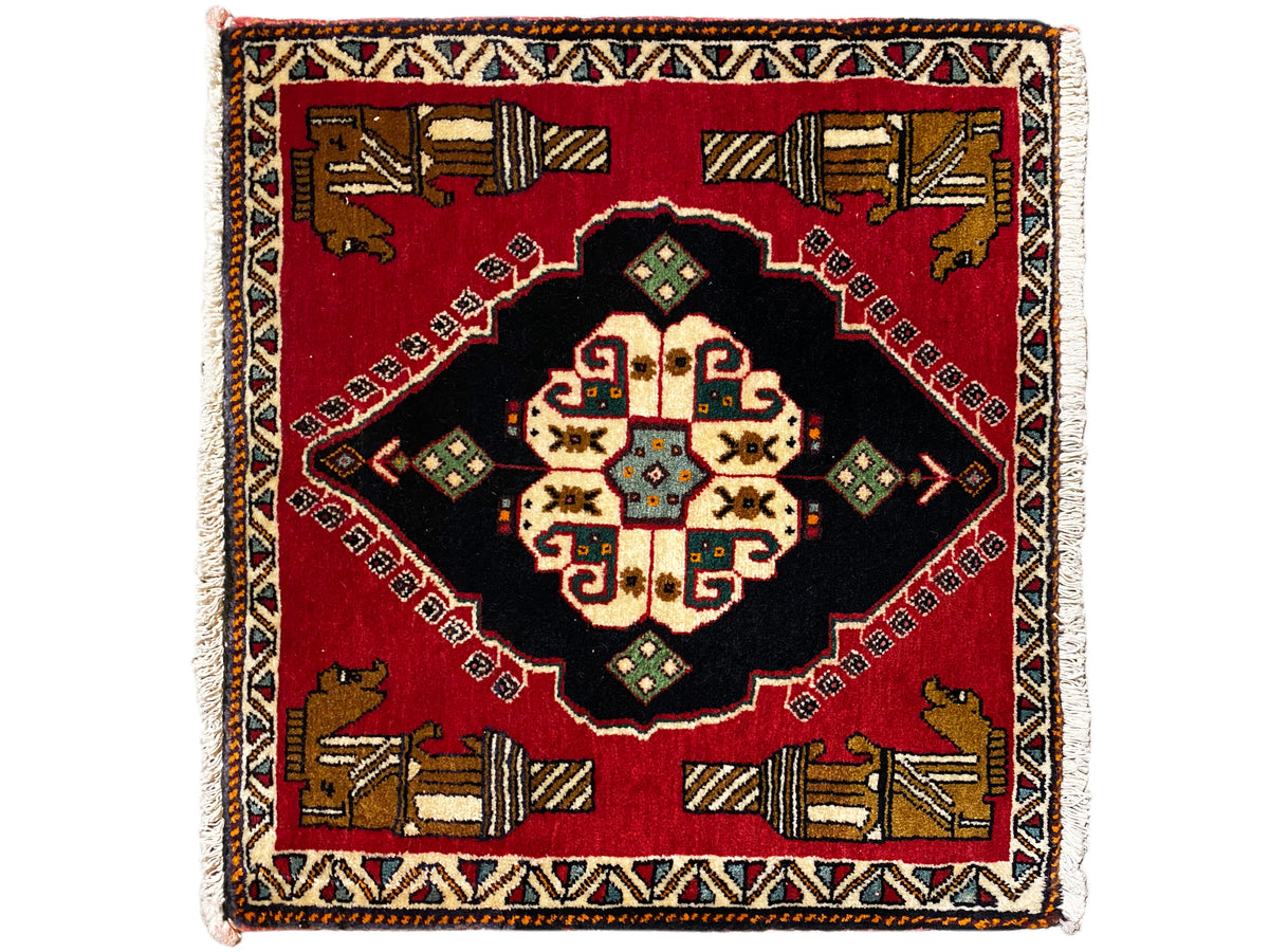 Poshti rug 63x55 cm: red area rug with a black center section and colorful geometric patterns
