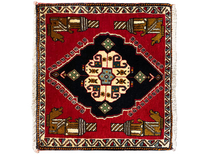 Poshti rug 63x55 cm: red area rug with a black center section and colorful geometric patterns