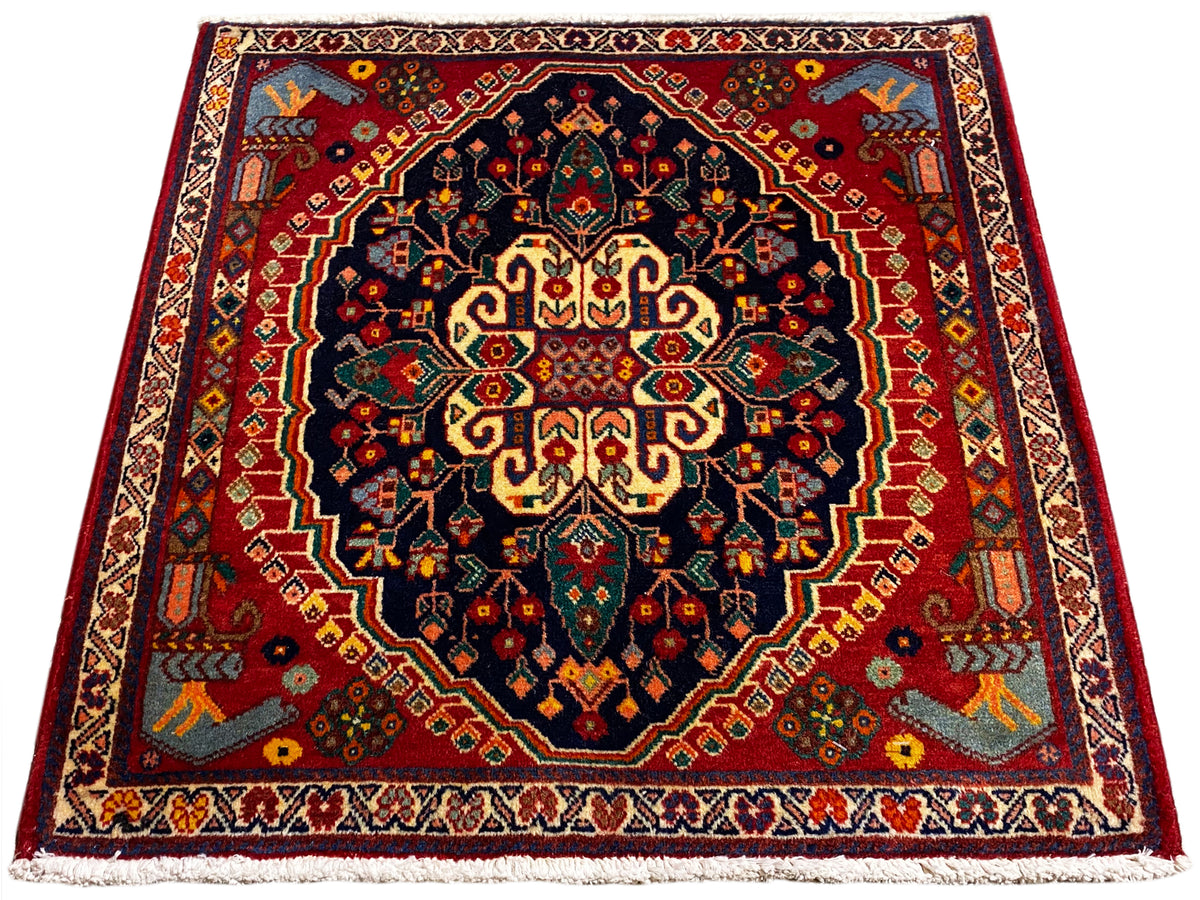 Square 67x60 cm rug with a centered pattern in dark blue, red, and yellow