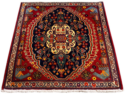 Square 67x60 cm rug with a centered pattern in dark blue, red, and yellow