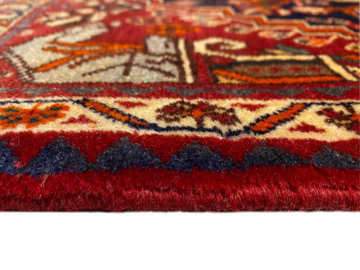 Carpet 65x59 cm close-up: red pile, surrounding border, and short fringes