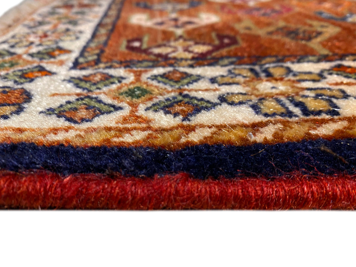 Poshti rug 60x55 cm close-up: fringes and multicolored woven pattern along the edge