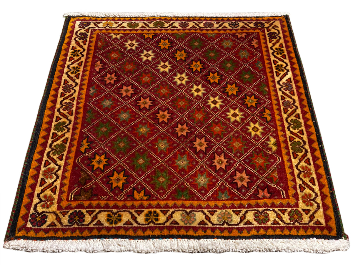 Poshti rug, rectangular, multicolored, with decorative border and fringes along the edges.
