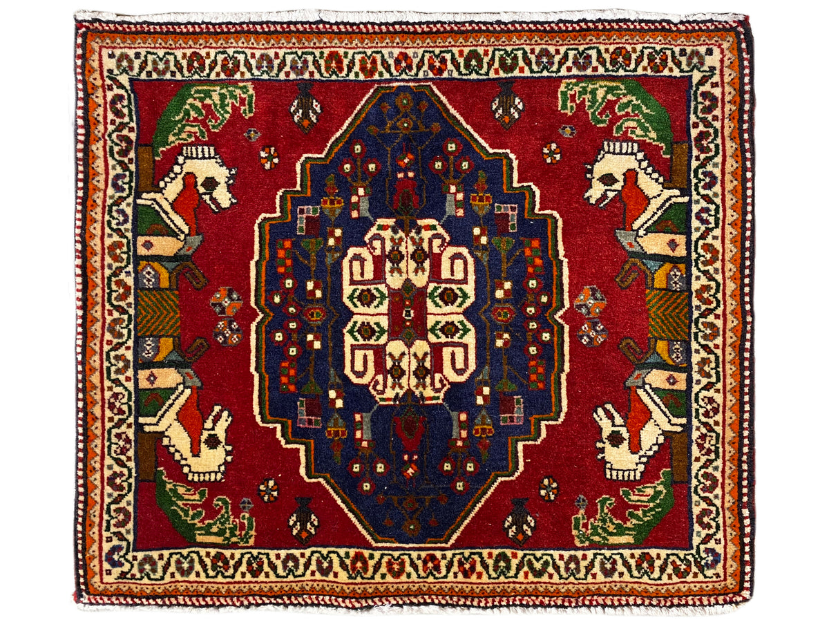 Poshti rug with a red ground, blue central medallion, and decorative border
