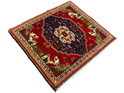 Poshti rug in diamond view, red field with a blue ornamental center