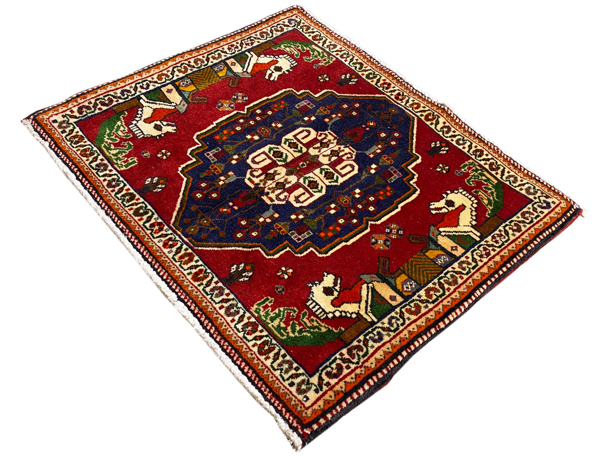 Poshti rug in a diamond shape, red background, blue medallion, and animal motifs