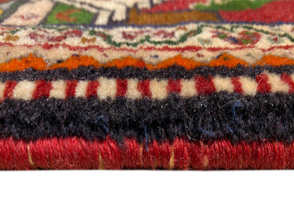 Poshti rug detail: multicolored pile with black and red fringed border