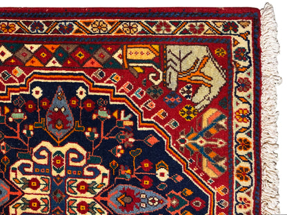 Close-up of the carpet edge with a blue ornamental field, red details, and fringe
