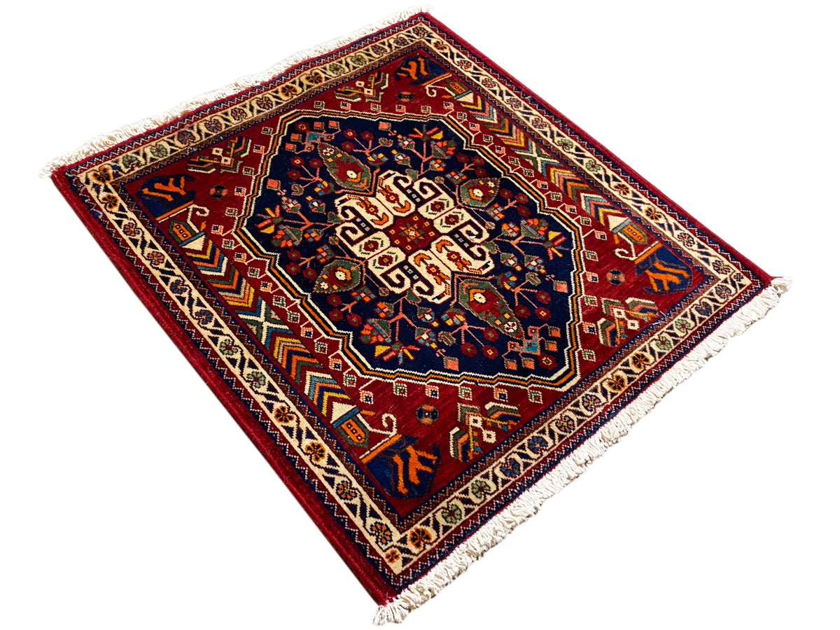 Rug 63x60 cm with a geometric ornamental pattern, blue center, and fringes