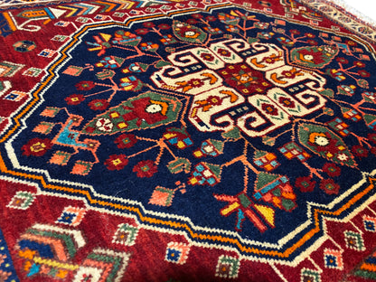 Close-up of 63x60 cm rug: colorful floral pattern on a dark blue background