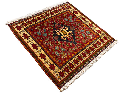 Rug 60x58 cm, diagonal view: red background, black medallion, corner fringes
