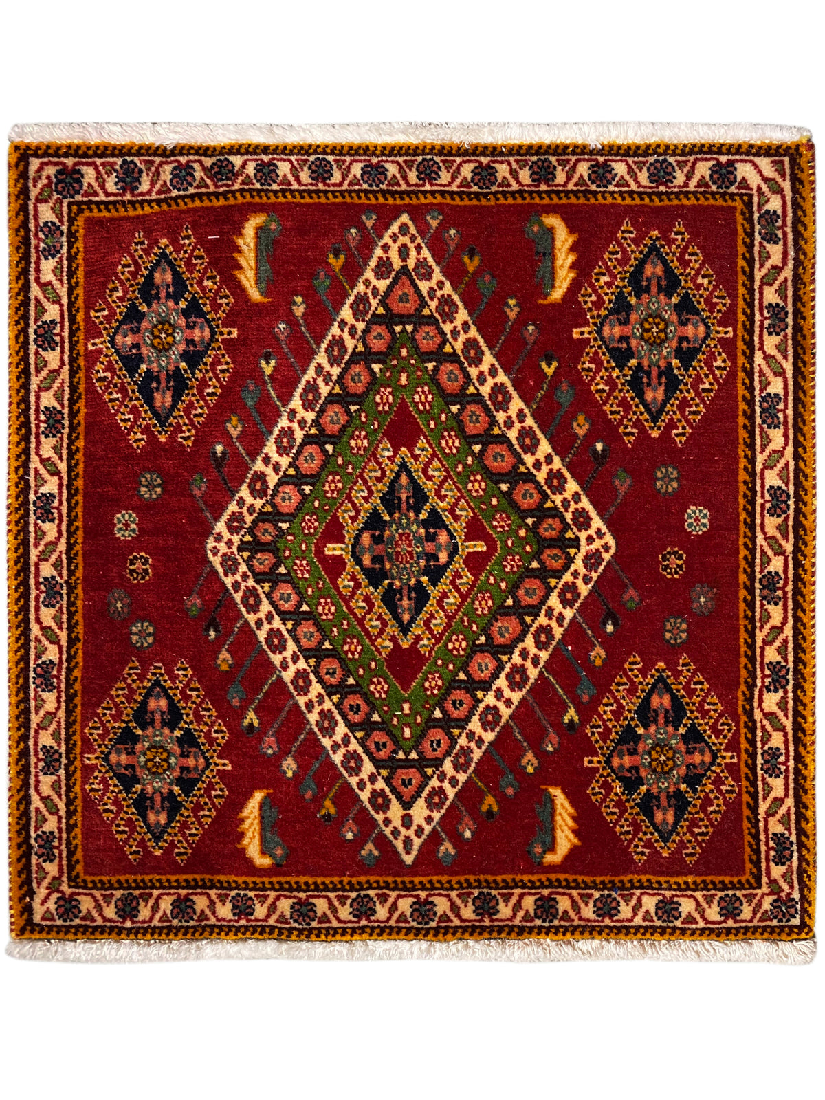 Poshti rug with a red background, geometric diamond pattern, and decorative border