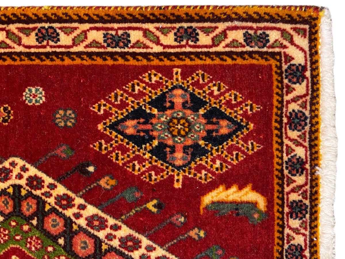 Poshti rug close-up: red pile with border and fringes