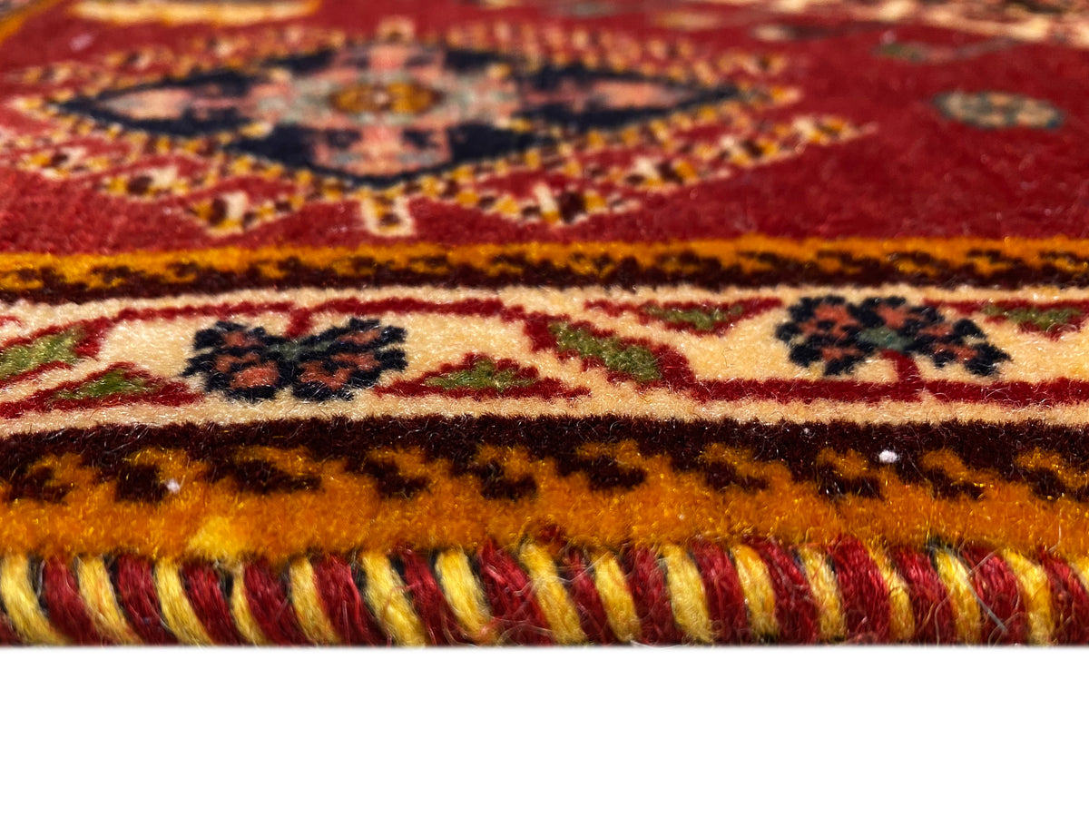 Poshteh rug detail at the edge: fringe trim and multicolored borders