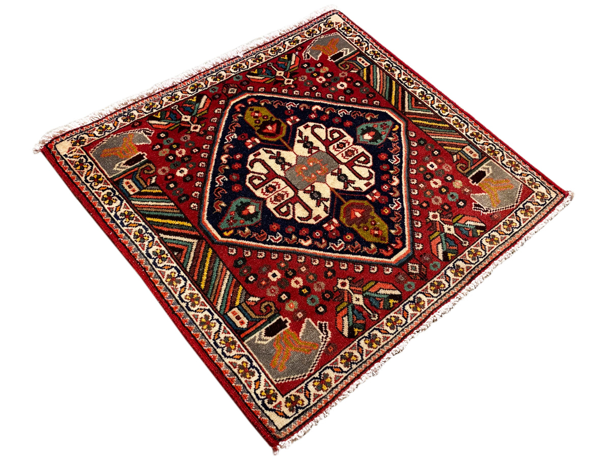 Square oriental rug with a red background and a blue-bordered central field