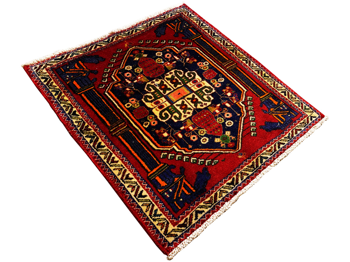 Poshti rug 66x62 cm laid out: red central field with a geometric pattern and corner motifs.