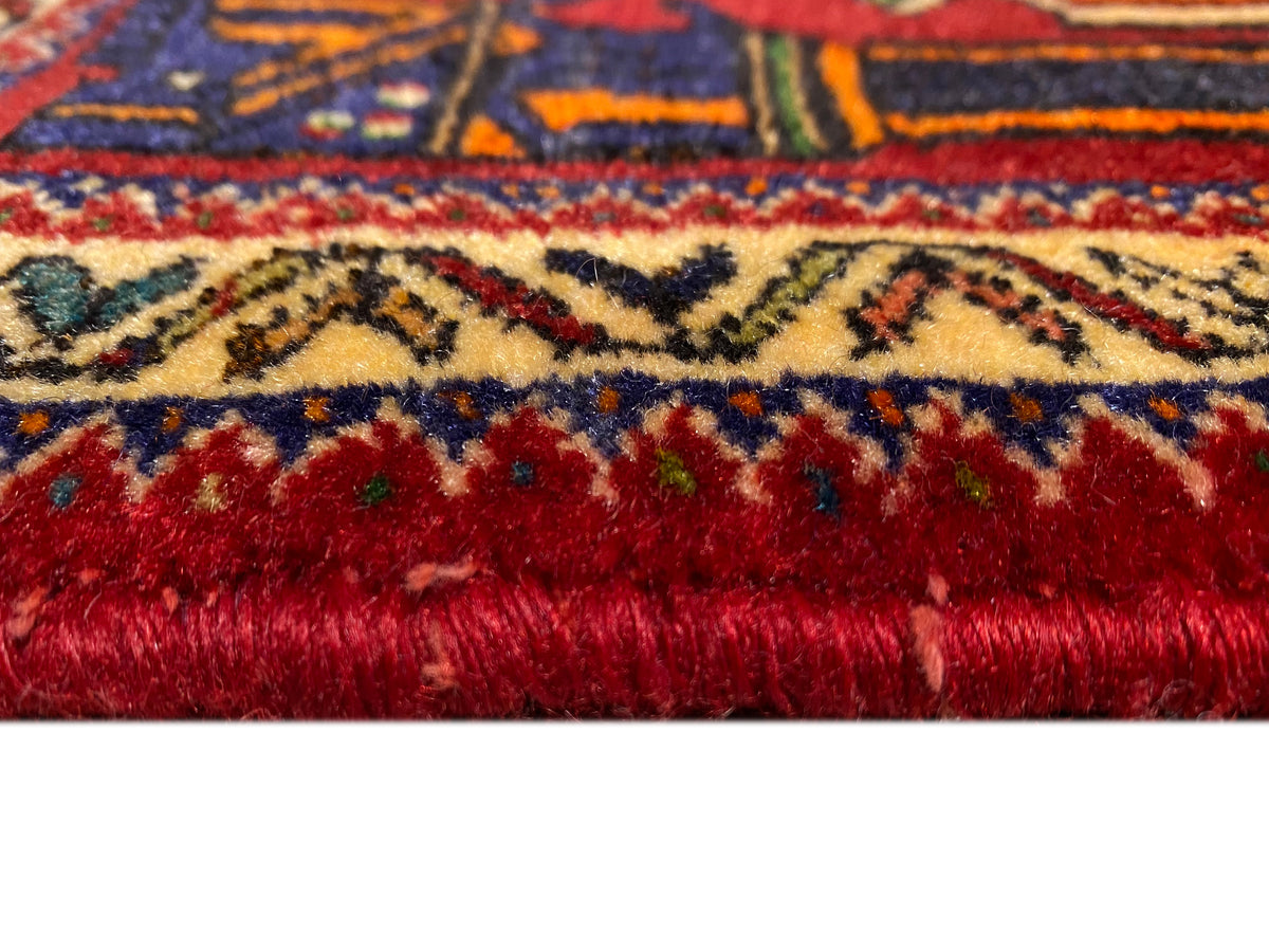 Poshti rug 66x62 cm Detail of the edge: dense red pile with a colored border.