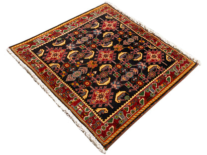 Rug with an ornamental central motif, black, red and yellow tones, green accents