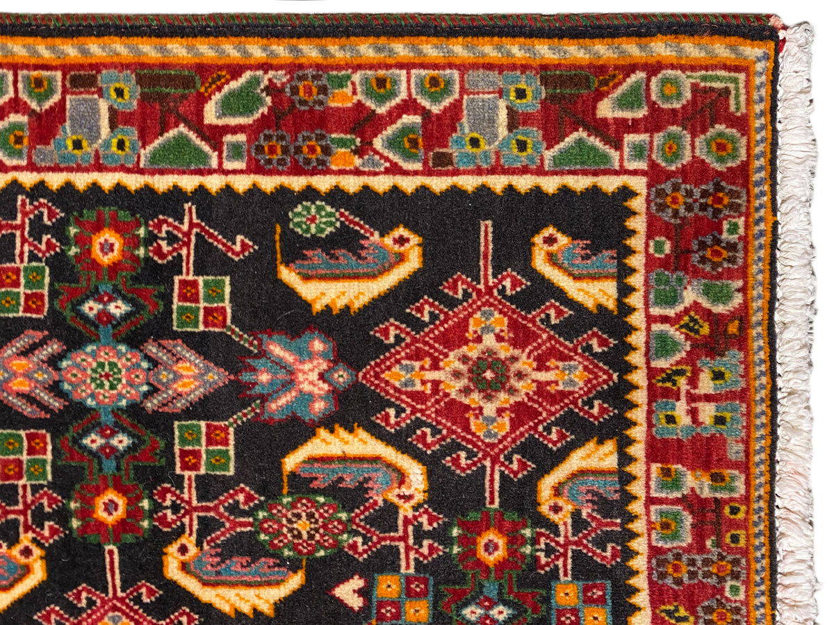 Carpet edge with a colorful border pattern, black, red, green, and yellow areas