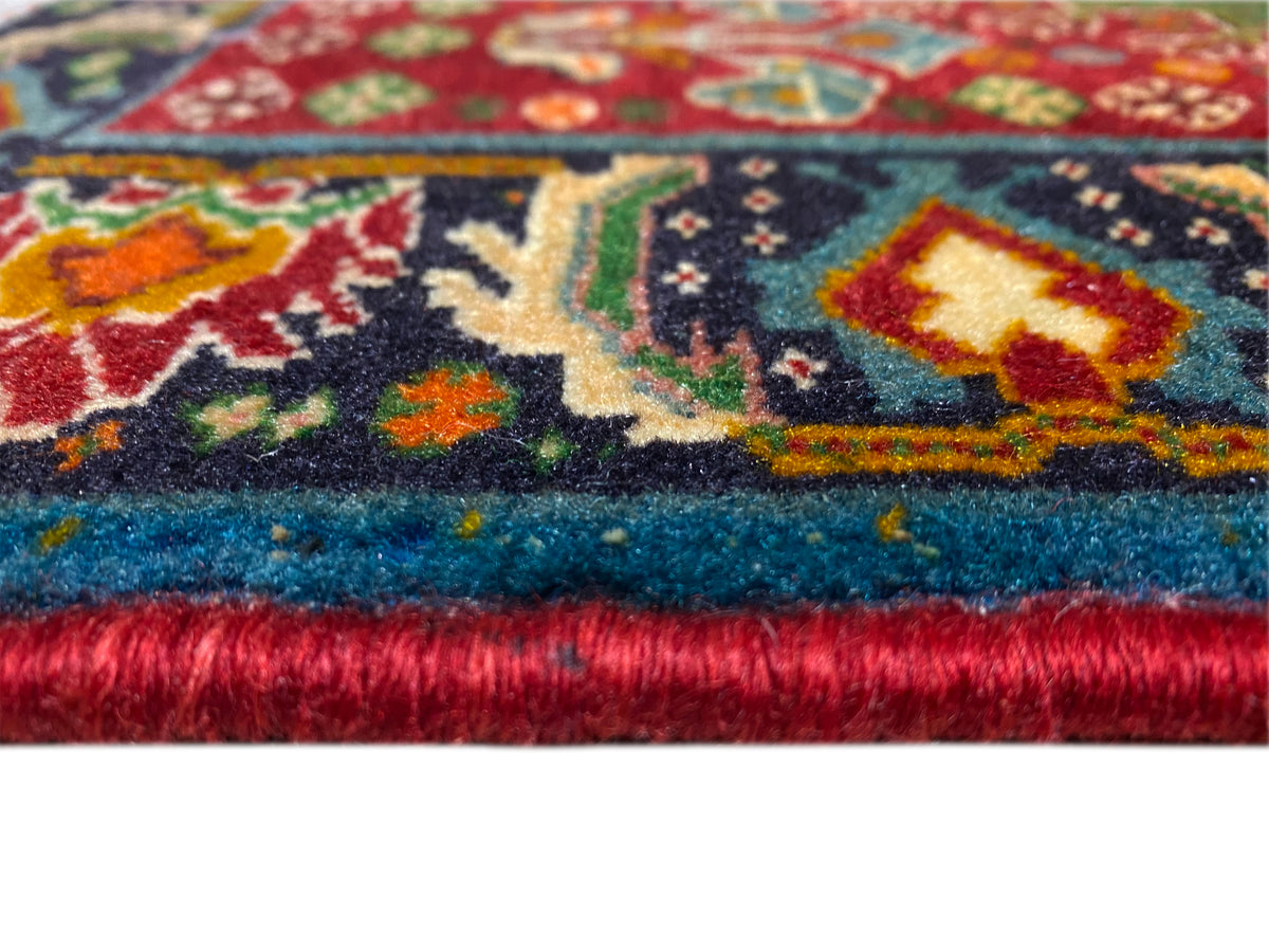 Rug edge detail: multicolored ornamental pattern and dense pile with fringed finish