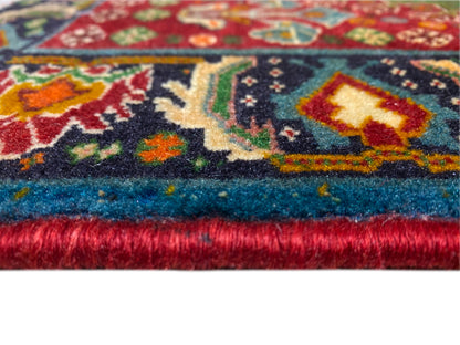 Rug edge detail: multicolored ornamental pattern and dense pile with fringed finish