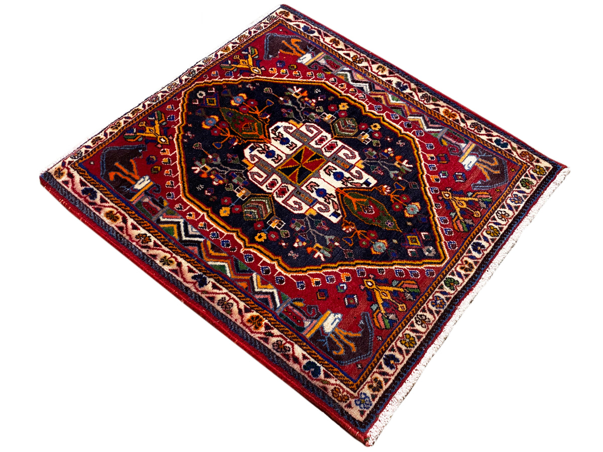 Square 70x67 cm rug: dark medallion with red border and ornamental trim